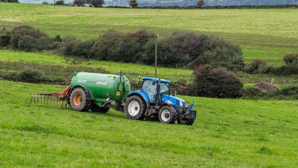  Timoleague, West Cork, dairy farmer Pa Harte spreads slurry on a grazing field.